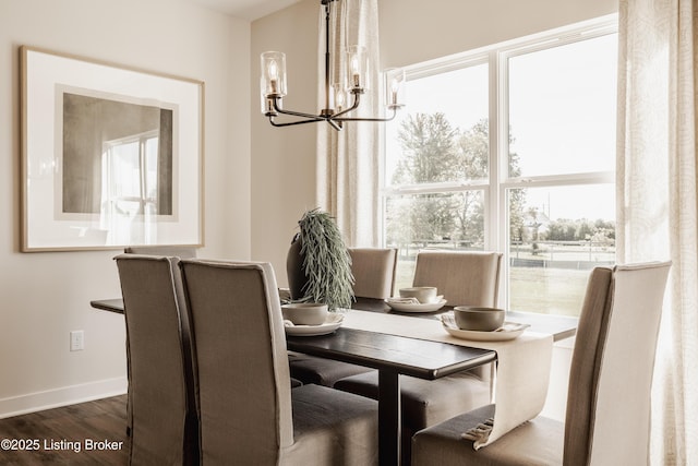 dining room featuring an inviting chandelier and dark wood-type flooring