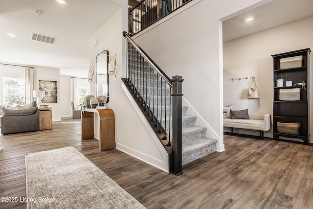 stairway with hardwood / wood-style floors