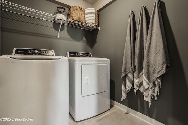 washroom featuring independent washer and dryer and light tile patterned flooring