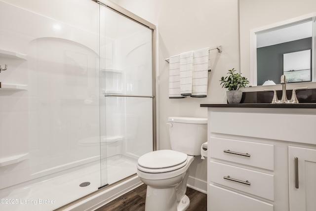 bathroom featuring toilet, walk in shower, and wood-type flooring