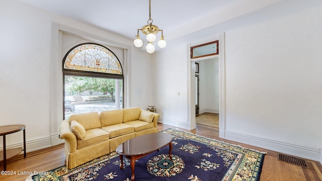 living room featuring hardwood / wood-style floors and a notable chandelier