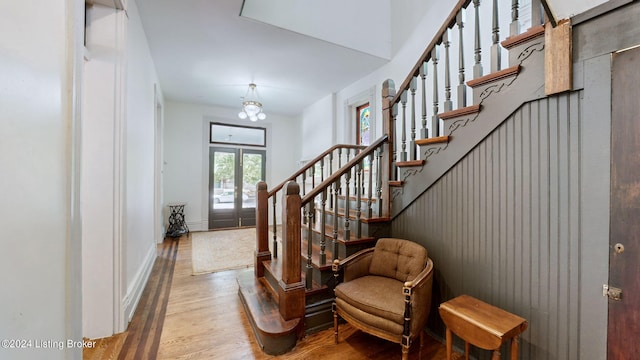 entryway with french doors and light hardwood / wood-style floors