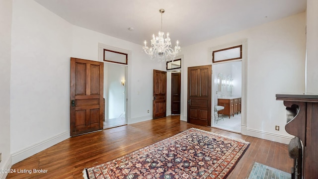 interior space with dark wood-type flooring and a chandelier