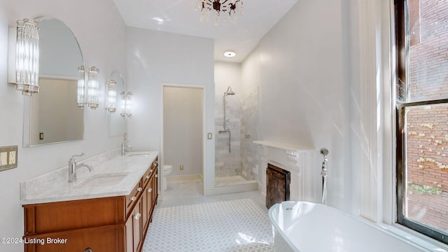 full bathroom with tile patterned flooring, a chandelier, toilet, vanity, and independent shower and bath