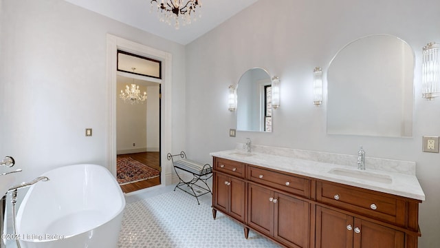 bathroom with vanity, a tub to relax in, tile patterned floors, and a notable chandelier