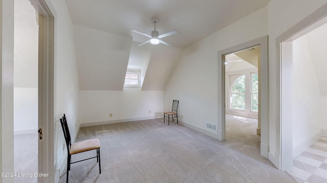 additional living space featuring ceiling fan, light colored carpet, and vaulted ceiling