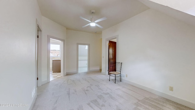 empty room featuring light colored carpet and ceiling fan