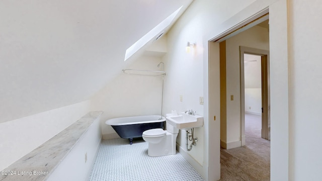 bathroom with sink, toilet, lofted ceiling, and a bath