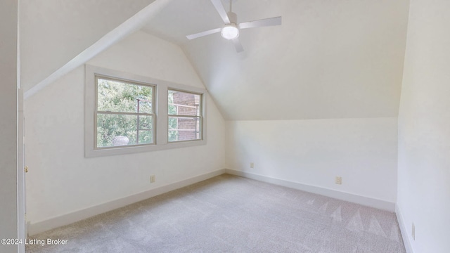 additional living space with light carpet, vaulted ceiling, and ceiling fan