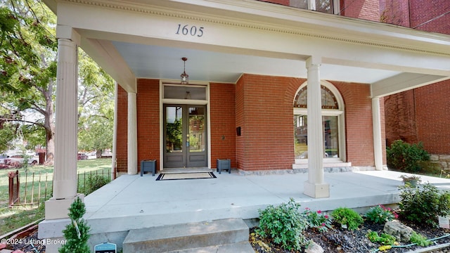 entrance to property with covered porch and french doors