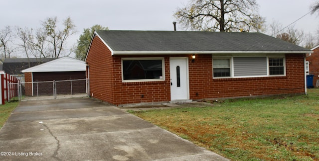 view of front of home with a garage, an outbuilding, and a front yard