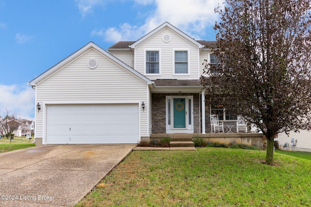 view of property with a front yard and a garage