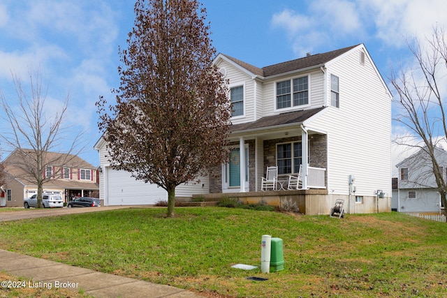 view of front of home with a porch, a front yard, and a garage