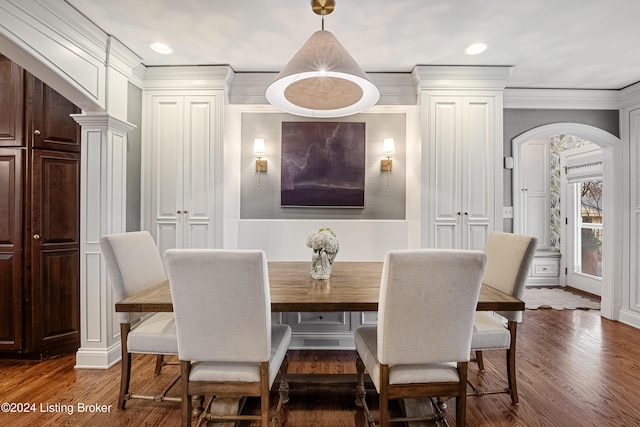 dining space with ornamental molding and dark hardwood / wood-style flooring