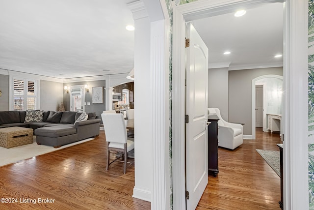 hallway featuring hardwood / wood-style flooring and ornamental molding