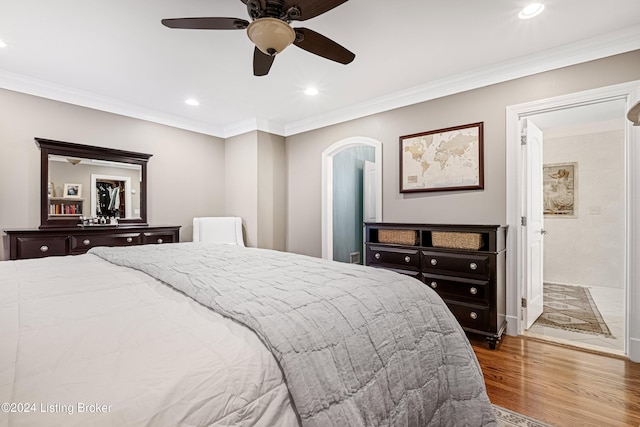 bedroom featuring hardwood / wood-style floors, ceiling fan, and ornamental molding