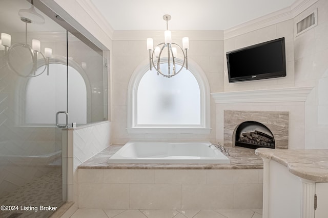 bathroom featuring tile patterned floors, vanity, a notable chandelier, ornamental molding, and independent shower and bath