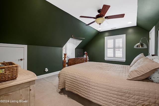 bedroom with ceiling fan, light colored carpet, and lofted ceiling