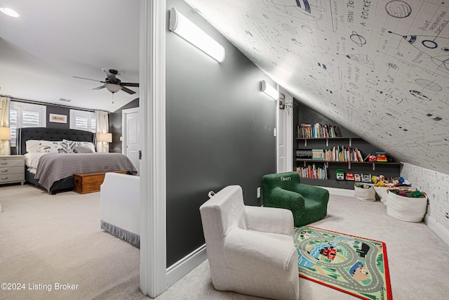 carpeted bedroom with ceiling fan and vaulted ceiling