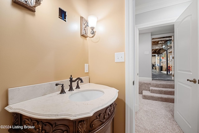 bathroom featuring crown molding and vanity