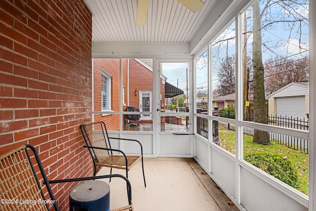 unfurnished sunroom featuring ceiling fan