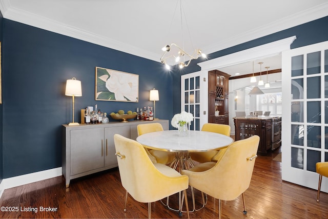 dining room featuring french doors, a chandelier, crown molding, and dark wood-type flooring