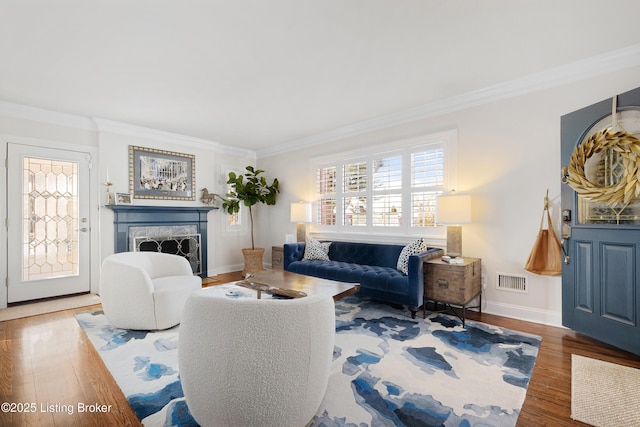 living room with ornamental molding and dark wood-type flooring