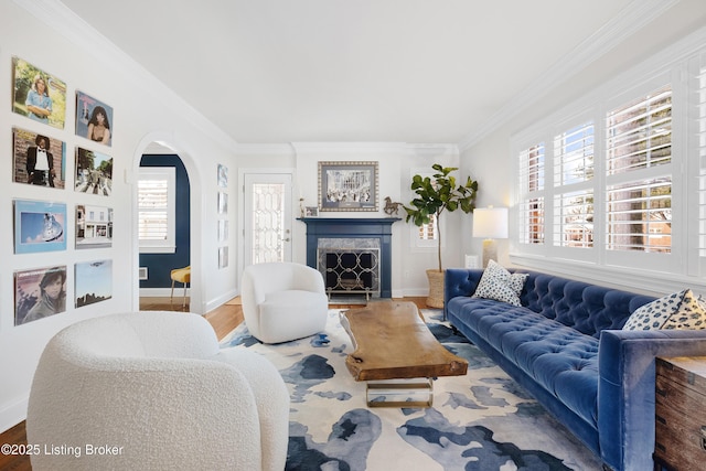 living room with crown molding, a wealth of natural light, and hardwood / wood-style flooring