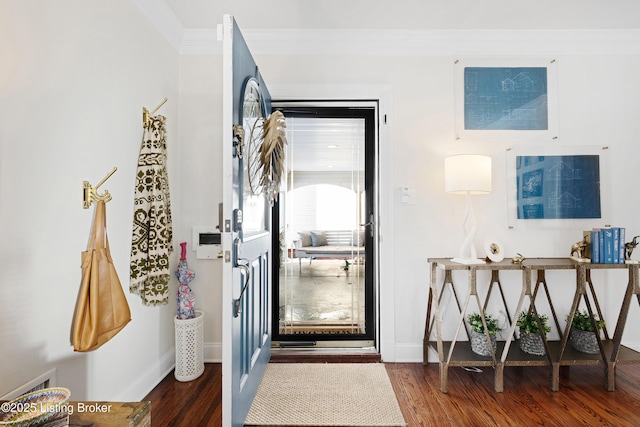 entryway with crown molding and dark hardwood / wood-style flooring