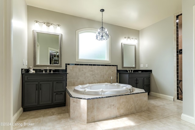 bathroom with tiled bath, tile patterned flooring, and vanity