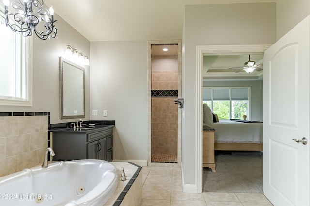 bathroom featuring tile patterned floors, ceiling fan with notable chandelier, plus walk in shower, and vanity