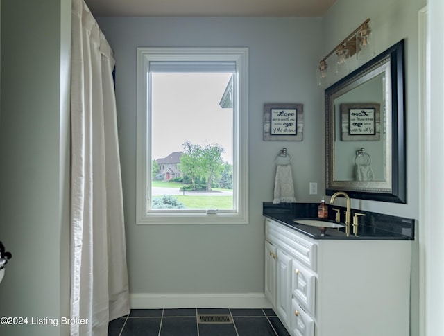 bathroom featuring tile patterned flooring and vanity