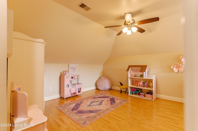 recreation room featuring hardwood / wood-style floors, ceiling fan, and lofted ceiling