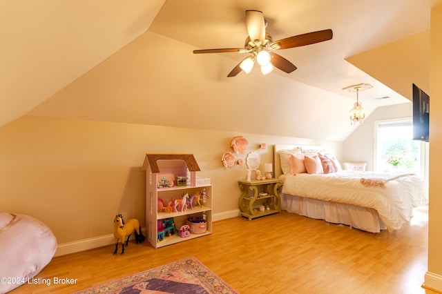 bedroom featuring hardwood / wood-style flooring, vaulted ceiling, and ceiling fan