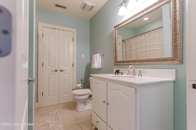 bathroom featuring tile patterned floors, vanity, and toilet