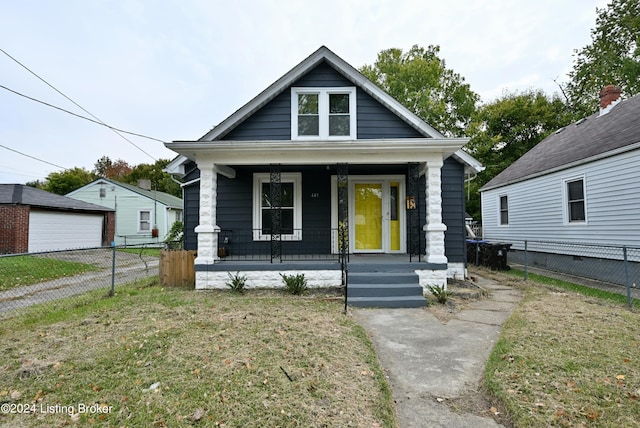 bungalow-style home featuring a porch and a front yard