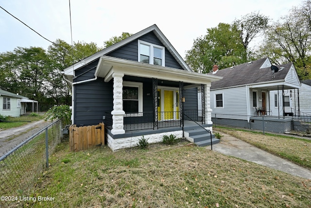 bungalow-style house featuring a porch and a front lawn