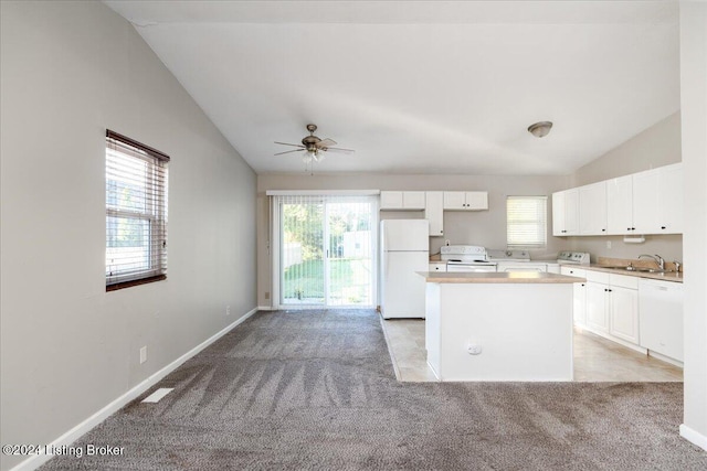 kitchen featuring white cabinets, white appliances, and vaulted ceiling