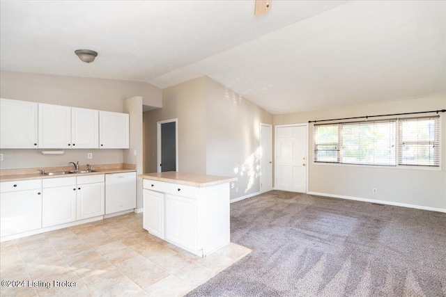 kitchen featuring a center island, light carpet, white cabinets, white dishwasher, and vaulted ceiling