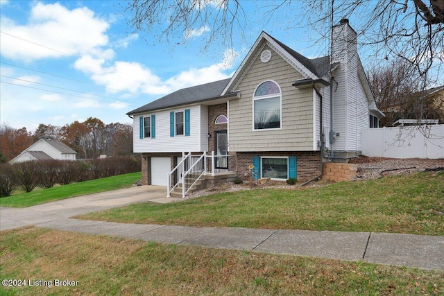 bi-level home with a garage and a front yard