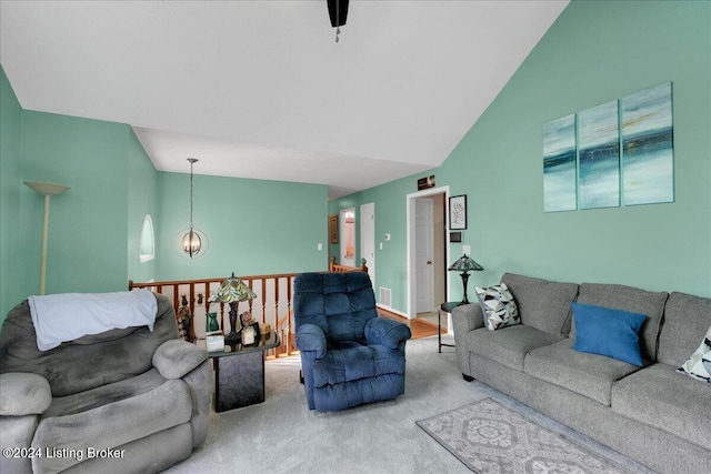 carpeted living room with lofted ceiling