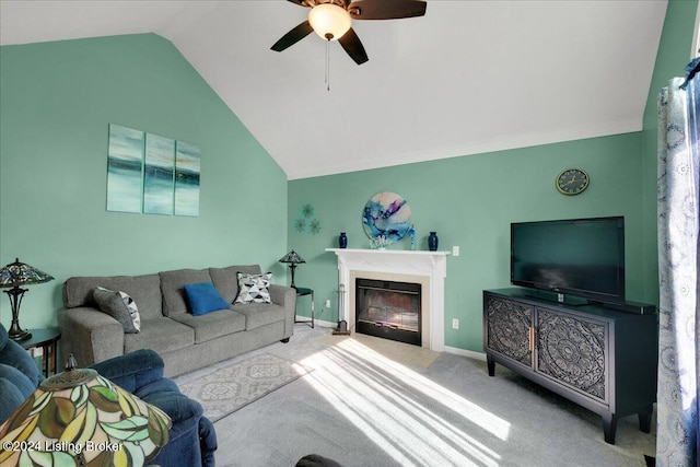 carpeted living room with a tiled fireplace, lofted ceiling, and ceiling fan