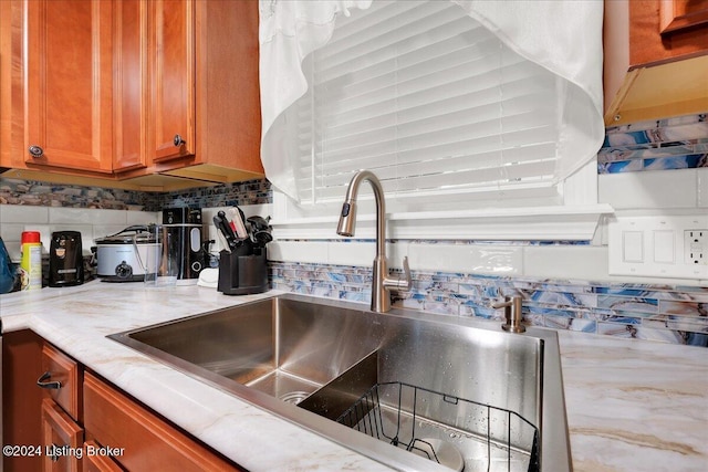 kitchen featuring sink and backsplash