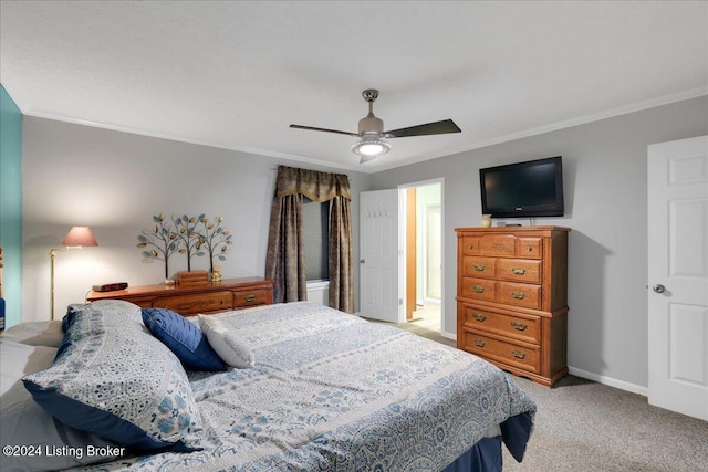 carpeted bedroom with ceiling fan and ornamental molding