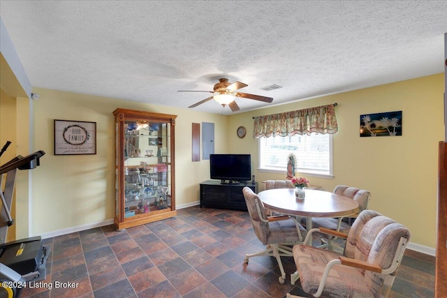 dining room featuring a textured ceiling and ceiling fan