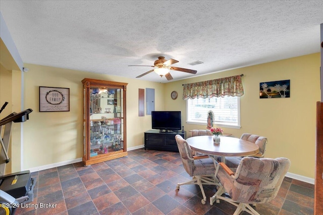 dining room featuring a textured ceiling and ceiling fan