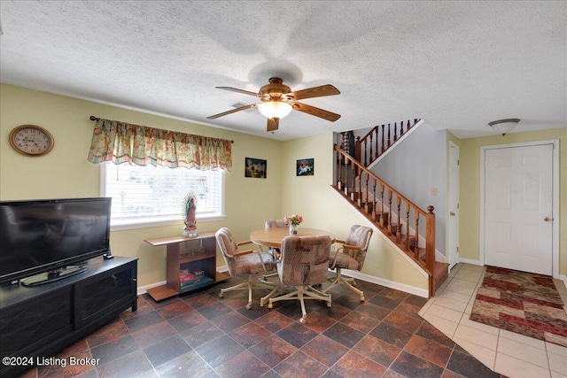 dining space featuring a textured ceiling and ceiling fan