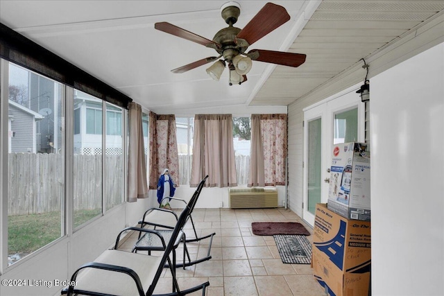 sunroom featuring ceiling fan and beam ceiling