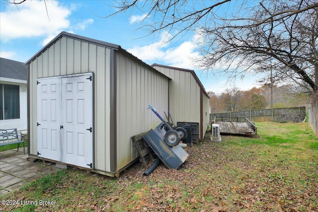 view of outbuilding with a yard