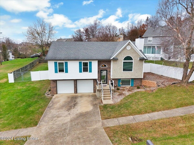 raised ranch featuring a garage and a front lawn